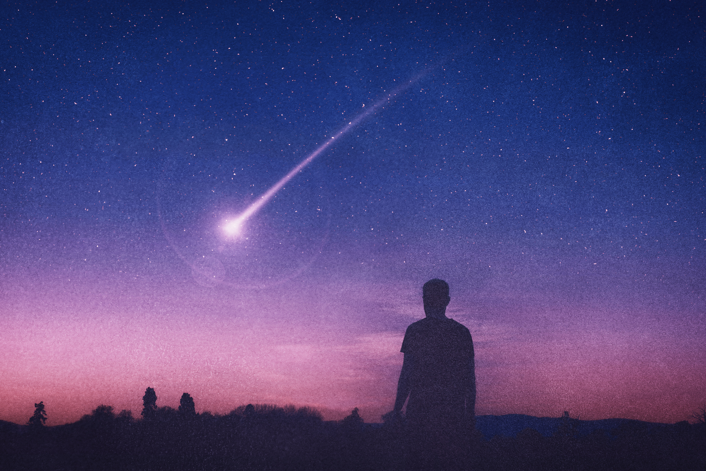 Silhouette of a Man Looking at a Shooting Star